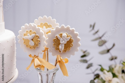Decorated sweets for a baptism party, angel and dove symbol of baptism