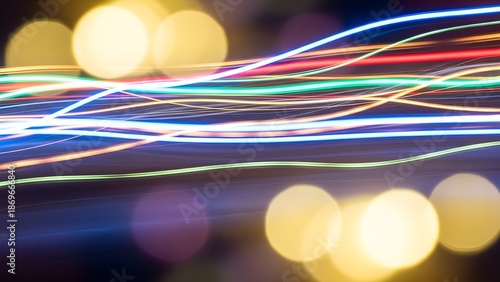 Abstract, motion-blurred light trails on a defocused bokeh background