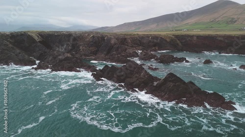 Scenic 4K aerial video of flying above spectacular Atlantic coastline, with picturesque rocks, cliffs and islands, Sybil head, Dingle Peninsula, Kerry, Ireland