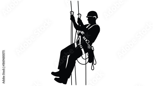 Silhouette of a worker rappelling down a rope with safety gear