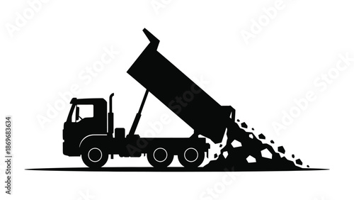 A silhouette of a dump truck unloading a pile of rocks or gravel