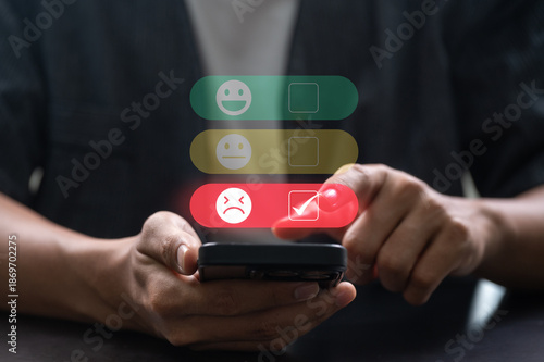 Photos Person giving bad feedback on smartphone with digital rating interface showing l