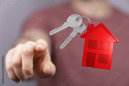 Hand pointing at house keys...