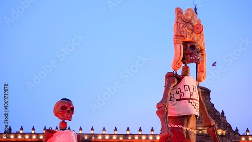  Giant skeletons in Zocalo during dusk, creating an eerie cultural scene 