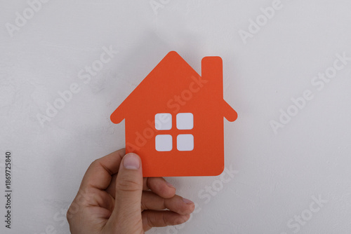An orange paper house cutou...
