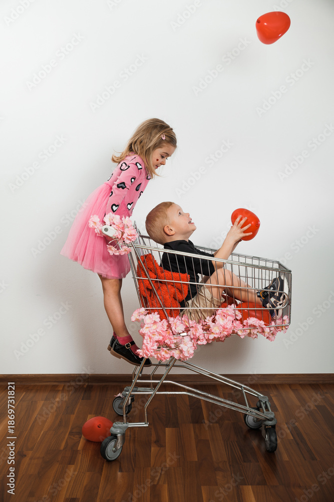 Ταπετσαρία Children play with red balloons in shopping cart at indoor location during dayti