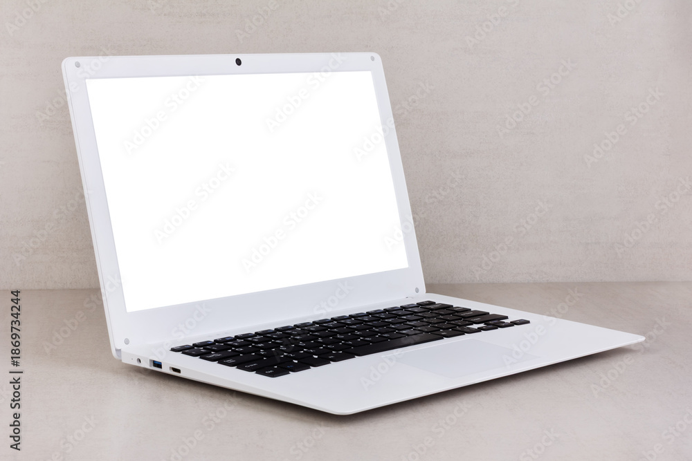 Fototapeta premium white mock up on a white laptop screen on a gray background close-up