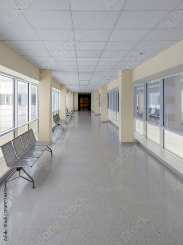Empty Modern Hospital Hallway with Metal Benches and Bright Windows