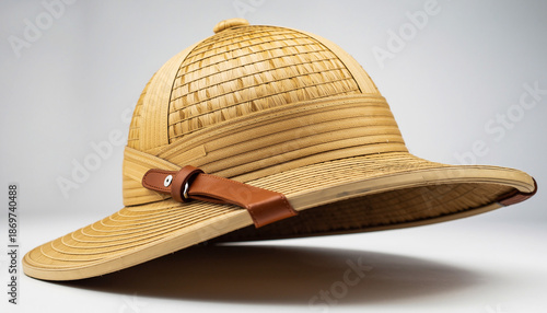 Straw Panama Hat with Leather Band Resting on White Surface.