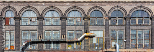 Facade of an abandoned old industrial building background