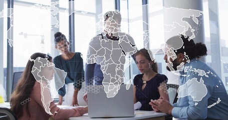Discussing business-casual team leaning over laptop in modern office, pointing at world map overlay