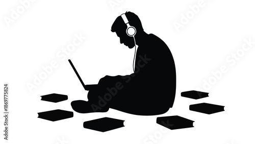 Silhouette of young adult student wearing headphones studying on laptop computer surrounded by books in quiet peaceful environment