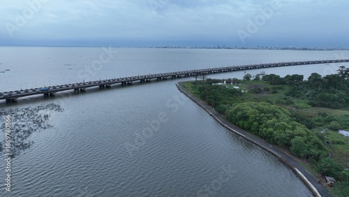 Wallpaper Mural Aerial view of the long bridge stretching over the water towards the city's skyline under a cloudy sky, Lagos, Lagos, Nigeria. Torontodigital.ca