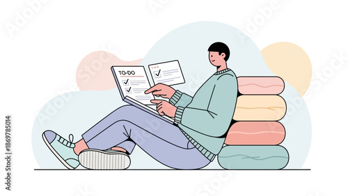 Man checking to-do list on laptop, sitting next to colorful cushions