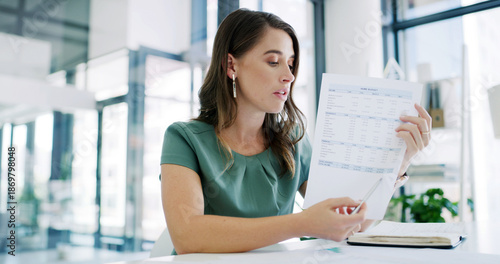 Photos Business woman, accountant and discussion with documents for finance, payslip or revenue in office