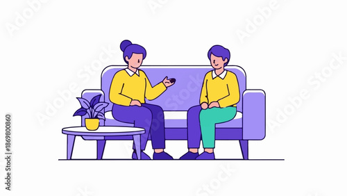 Two people in colorful clothes sit on a sofa, conversing beside a table with a plant