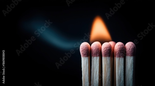 Burning matchsticks with flame against a dark background, macro shot
