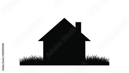 Simple black silhouette of a house with a chimney and surrounding grass
