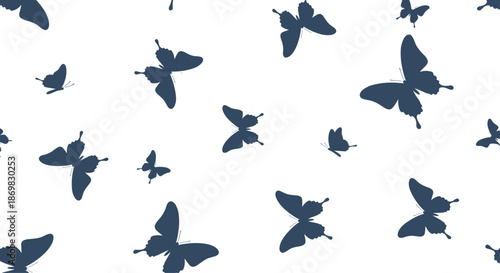 Seamless pattern of dark blue butterfly silhouettes in various sizes flying gracefully on a clean white background design.