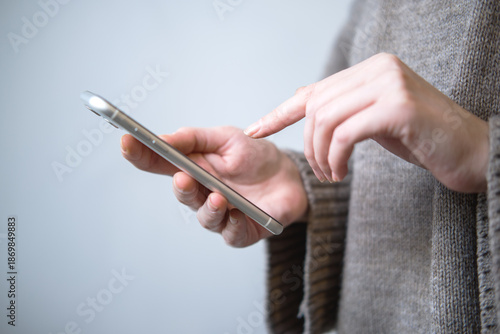 Close-up of young woman using phone.