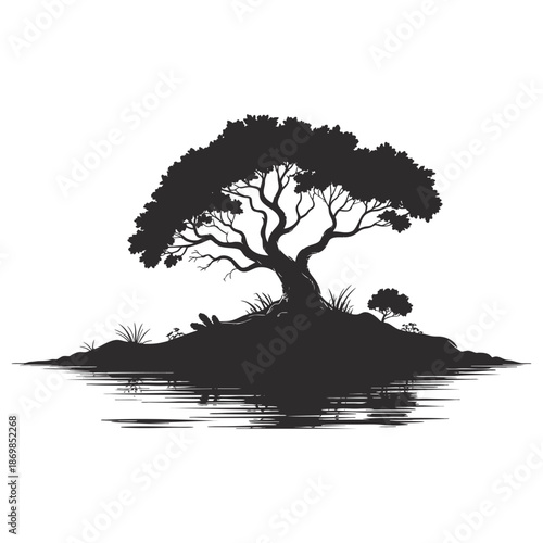 Silhouette of a majestic, ancient tree with sprawling branches reflected in calm water.