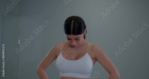 Young woman practicing neck flexion and extension in a studio during a wellness session