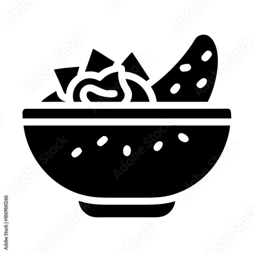 Delicious nachos with savory dip served in a classic bowl, perfect for a snack or party appetizer