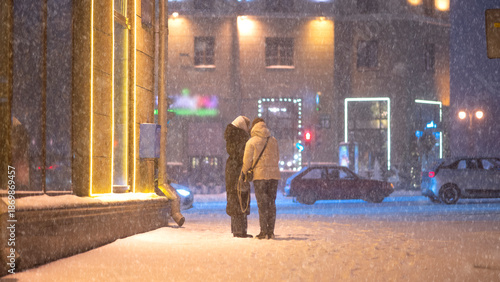 Snowfall in the evening city under the streetlights. Winter Minsk