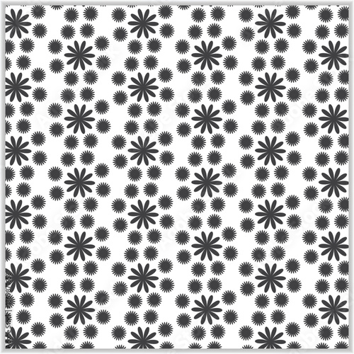 Black and white floral pattern with repeating snowflake like designs on a white background