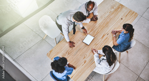 Teamwork, meeting and above of doctors on tablet for online results, medical report and research. Hospital, mockup space and people on tech for planning surgery, consulting or diagnosis on screen