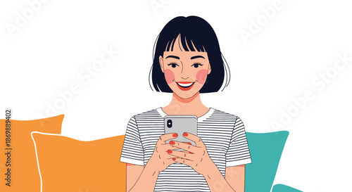 Happy young woman with short dark hair smiling while looking at her smartphone and sitting on a sofa with colorful pillows.