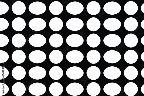 Φωτογραφία A black and white pattern of evenly spaced white circles on a black background