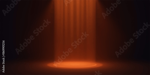 Warm orange spotlight shining down on a dark background with curtains