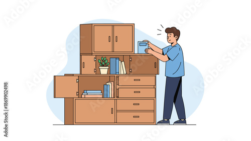 Young man happily organizing and placing his books into a large modern wooden modular bookshelf or storage unit.