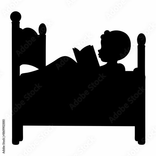A Silhouette of a Child Reading in Bed Before Sleep Time