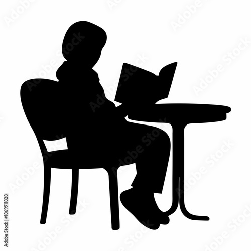 Silhouette of a person reading at a table sitting in a chair
