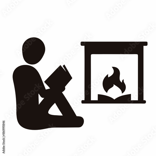 A person reads a book next to a fireplace on a cold night