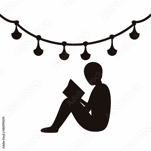 Silhouette of a person reading a book under decorative hanging lights