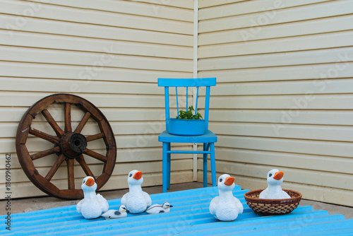 A blue chair sits in front of a white wall
