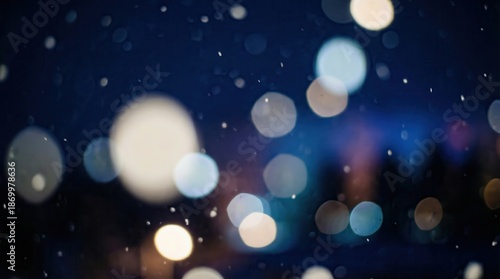 Abstract blue background with glowing particles in motion featuring shiny bokeh lights and a festive defocused glitter pattern for a bright holiday celebration design