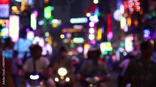 Bokeh view of busy Bui Vien Walking Street - famous New Year party area of Ho Chi Minh City (Saigon), Vietnam. Blurred background footage.