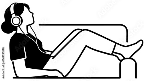 A person relaxing on a sofa listening to music with headphones