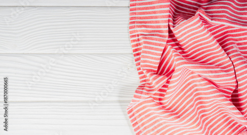 Natural cotton kitchen towels on a wooden table.