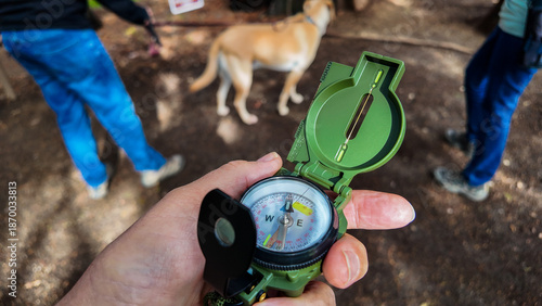 Fotografía A Compass being used on the trail to find direction using the magnetic field of