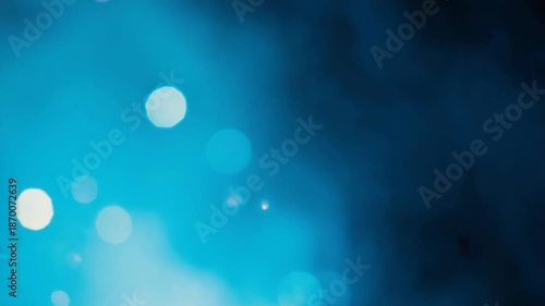 Vibrant blue background with dynamic white bokeh lights - 4k video