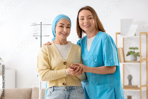 Young woman undergoing chemical therapy course with nurse at home. Brain canc...