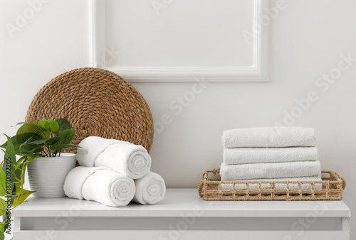 Clean towels with plant on ...