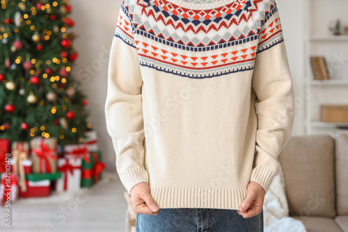 Young man in sweater at hom...