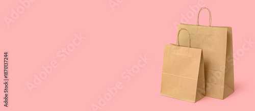 Paper shopping bags on pink...