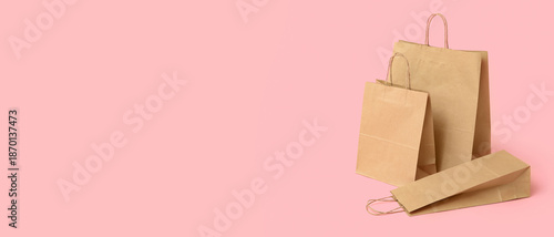 Paper shopping bags on pink...